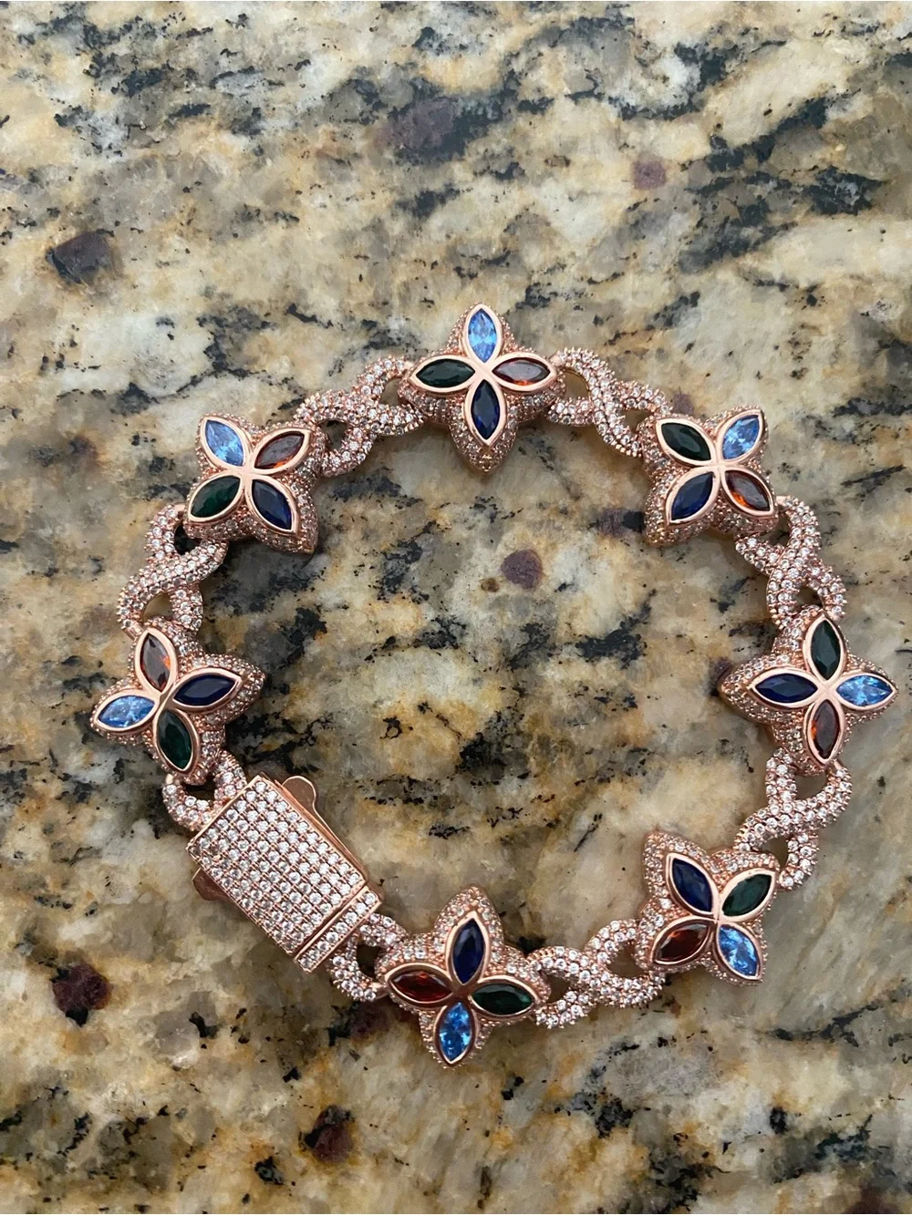 Sterling silver and moissanite floral bracelet with multi colored stones.